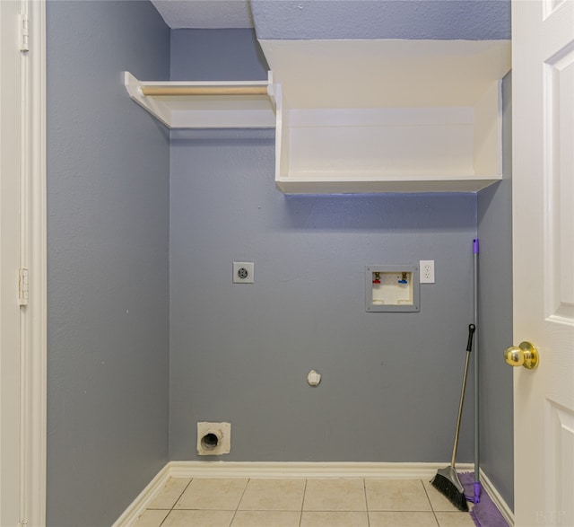 washroom with hookup for a gas dryer, light tile patterned flooring, electric dryer hookup, and hookup for a washing machine