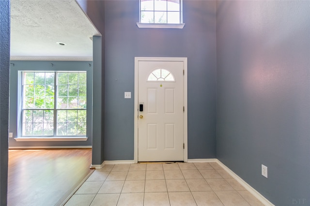 tiled entryway with a textured ceiling