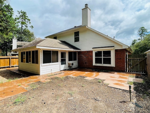 back of house featuring a patio and a sunroom