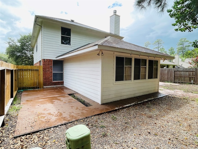 back of property with a patio