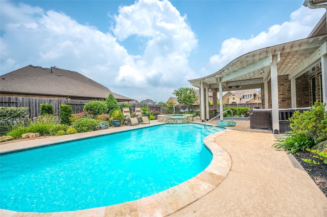 view of swimming pool with an in ground hot tub and a patio area