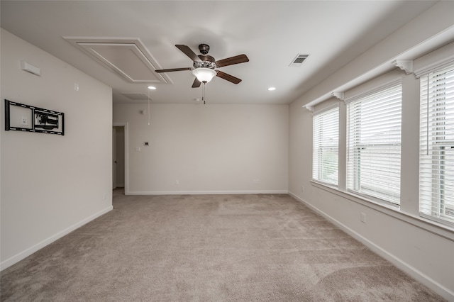 carpeted spare room with ceiling fan and a healthy amount of sunlight