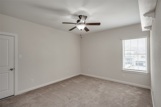 spare room with light carpet and ceiling fan