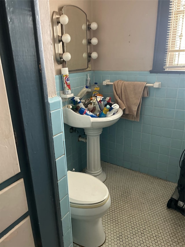 bathroom with backsplash, tile walls, toilet, and tile patterned floors