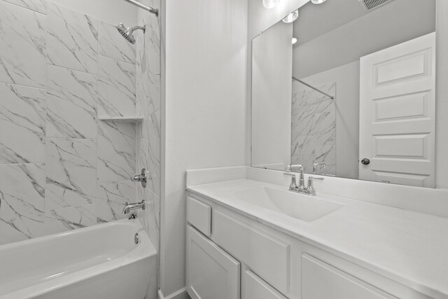 bathroom featuring vanity and tiled shower / bath combo