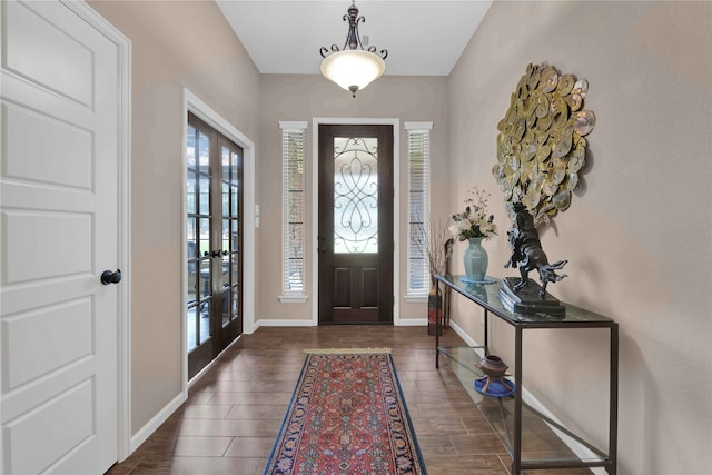 foyer with french doors and dark hardwood / wood-style flooring