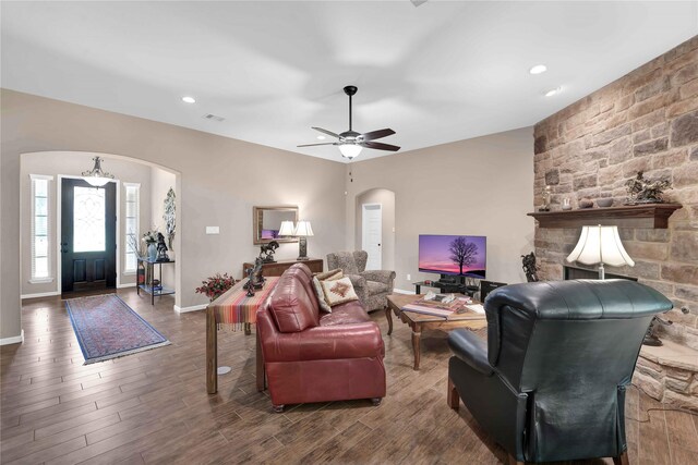 living room featuring ceiling fan and dark hardwood / wood-style flooring