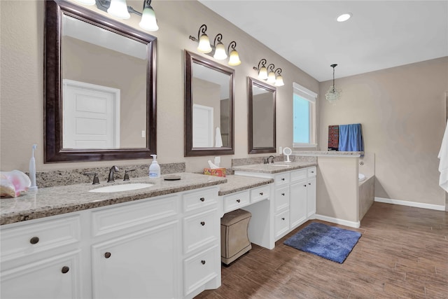 bathroom featuring a bathtub, hardwood / wood-style flooring, and vanity