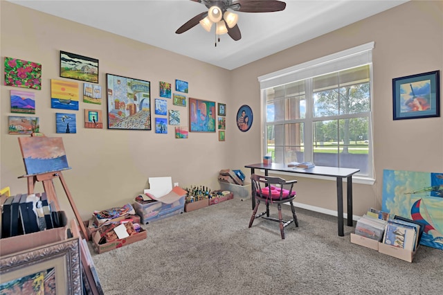 recreation room with ceiling fan and carpet