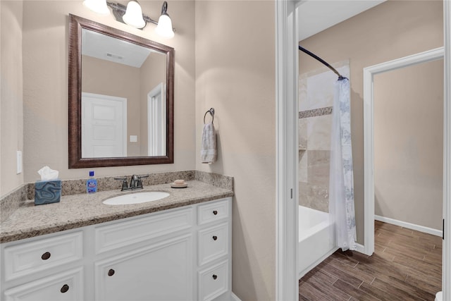 bathroom featuring vanity and shower / bath combination with curtain