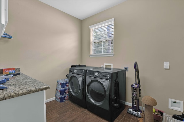 laundry room with washer and dryer and dark hardwood / wood-style floors