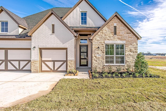 view of front of house with a garage and a front yard