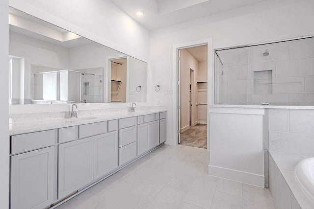 bathroom featuring tile patterned floors, vanity, and shower with separate bathtub