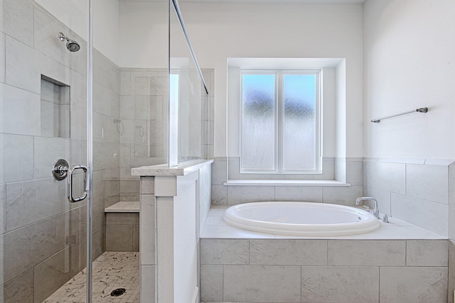 bathroom featuring independent shower and bath