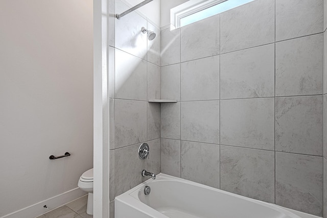 bathroom with toilet, tiled shower / bath, and tile patterned flooring