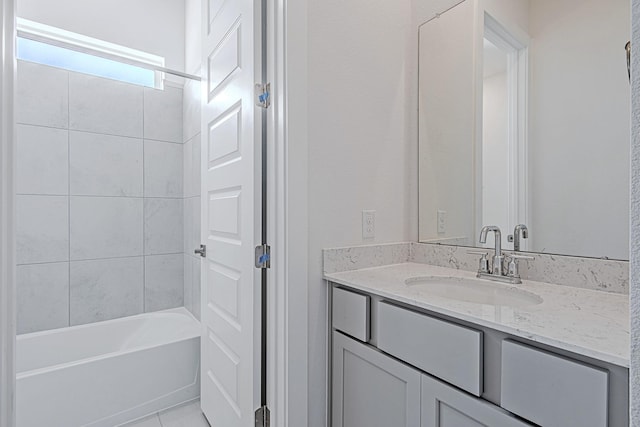 bathroom with vanity, tiled shower / bath combo, and tile patterned floors