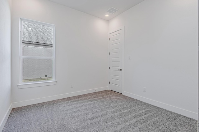 carpeted empty room featuring plenty of natural light