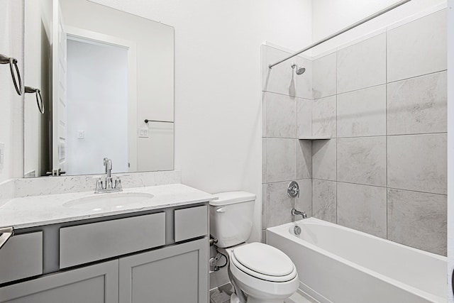 full bathroom with toilet, tiled shower / bath combo, and vanity