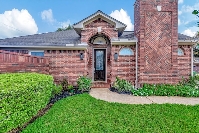 doorway to property featuring a yard