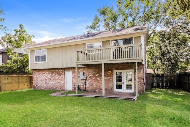 back of property featuring a yard and french doors