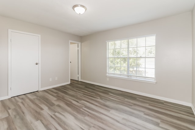 empty room with hardwood / wood-style floors