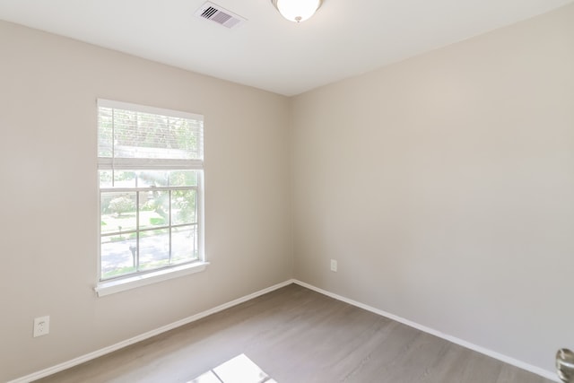 unfurnished room featuring hardwood / wood-style flooring