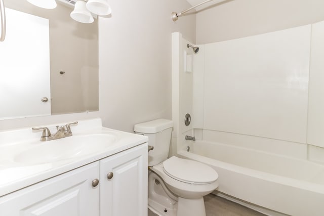 full bathroom with vanity, toilet, hardwood / wood-style flooring, and shower / bath combination