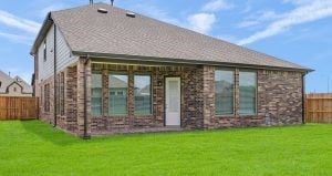 rear view of house featuring a lawn