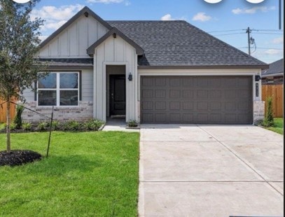 view of front of house with a garage and a front lawn