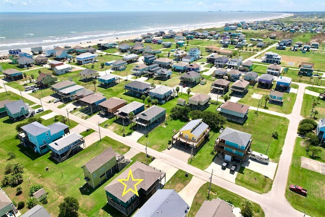 aerial view with a water view and a beach view