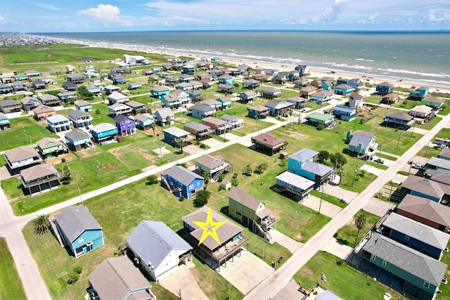 birds eye view of property with a water view and a view of the beach