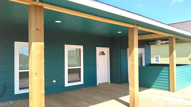 view of exterior entry featuring a wooden deck