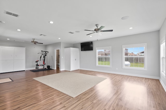 exercise area with ceiling fan and hardwood / wood-style flooring