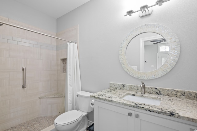 bathroom featuring toilet, a shower with curtain, ceiling fan, and vanity