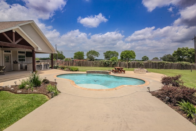 view of swimming pool featuring a patio area, a lawn, and a hot tub