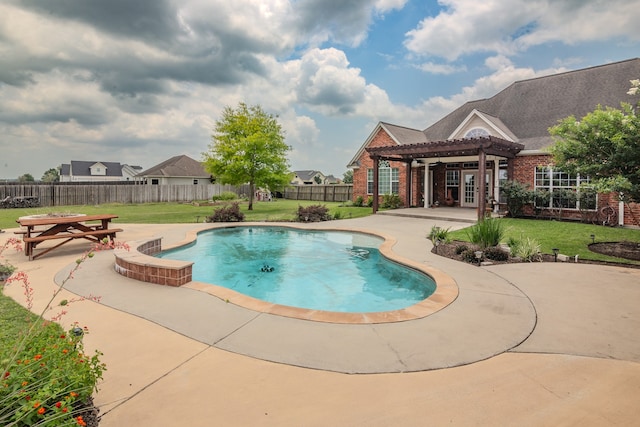 view of pool with a pergola, a lawn, and a patio area