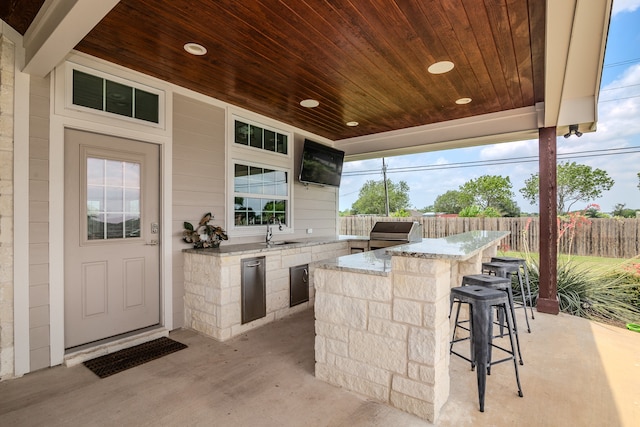 view of patio with a grill, an outdoor wet bar, and area for grilling