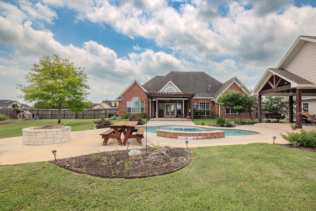 view of pool featuring a fire pit, an in ground hot tub, a yard, and a patio