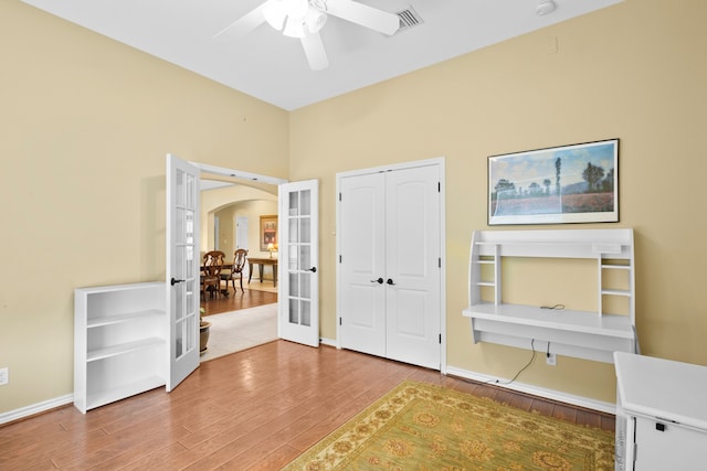 entrance foyer with ceiling fan, hardwood / wood-style floors, and french doors