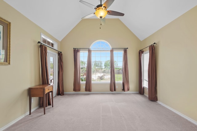 empty room featuring high vaulted ceiling, ceiling fan, and light carpet