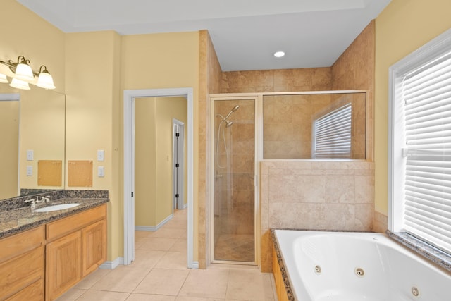 bathroom with tile patterned floors, independent shower and bath, and vanity