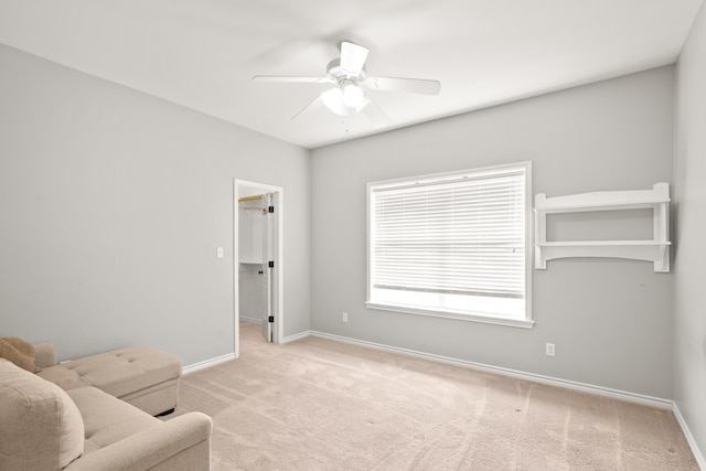 sitting room featuring ceiling fan and light colored carpet