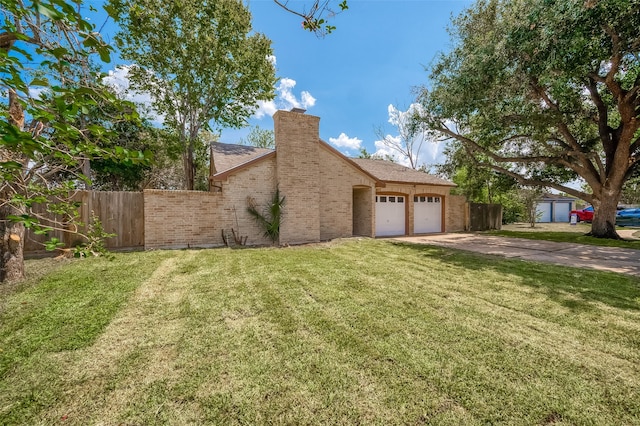 view of front of property with a garage and a front lawn