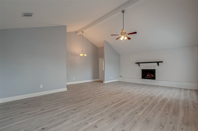 unfurnished living room with ceiling fan, light wood-type flooring, vaulted ceiling with beams, and a fireplace