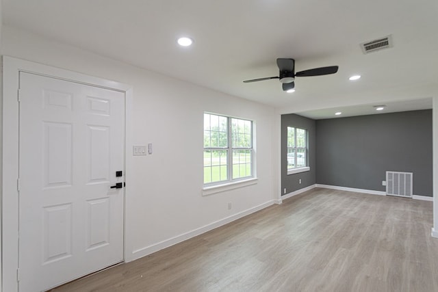 unfurnished room with ceiling fan and light hardwood / wood-style floors