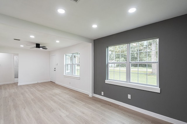 unfurnished room with light wood-type flooring and ceiling fan