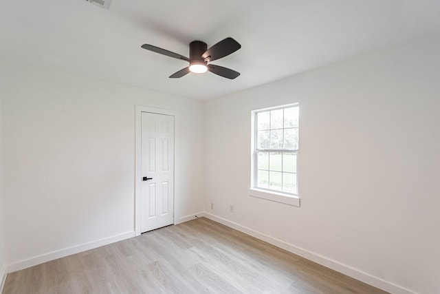 empty room featuring ceiling fan and light wood-type flooring