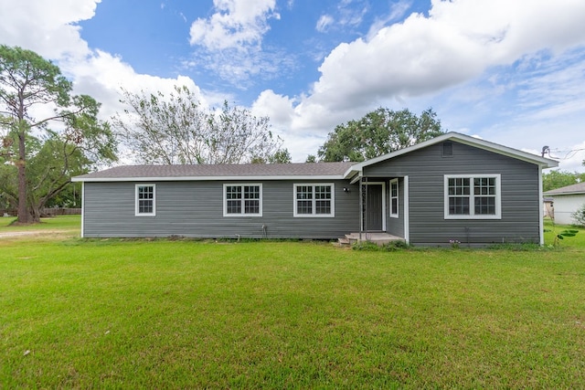 rear view of property with a yard