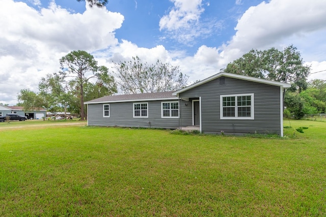 back of property featuring a yard