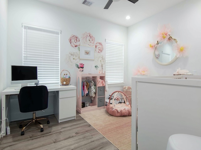 home office featuring ceiling fan and light hardwood / wood-style flooring